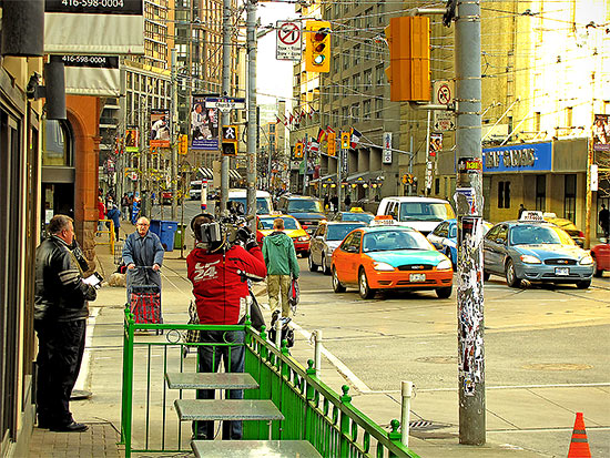 cameraman, cp24, news, reporter, cam woolley, church street, carlton street, maple leaf gardens, taxis, traffic lights, toronto, city, life